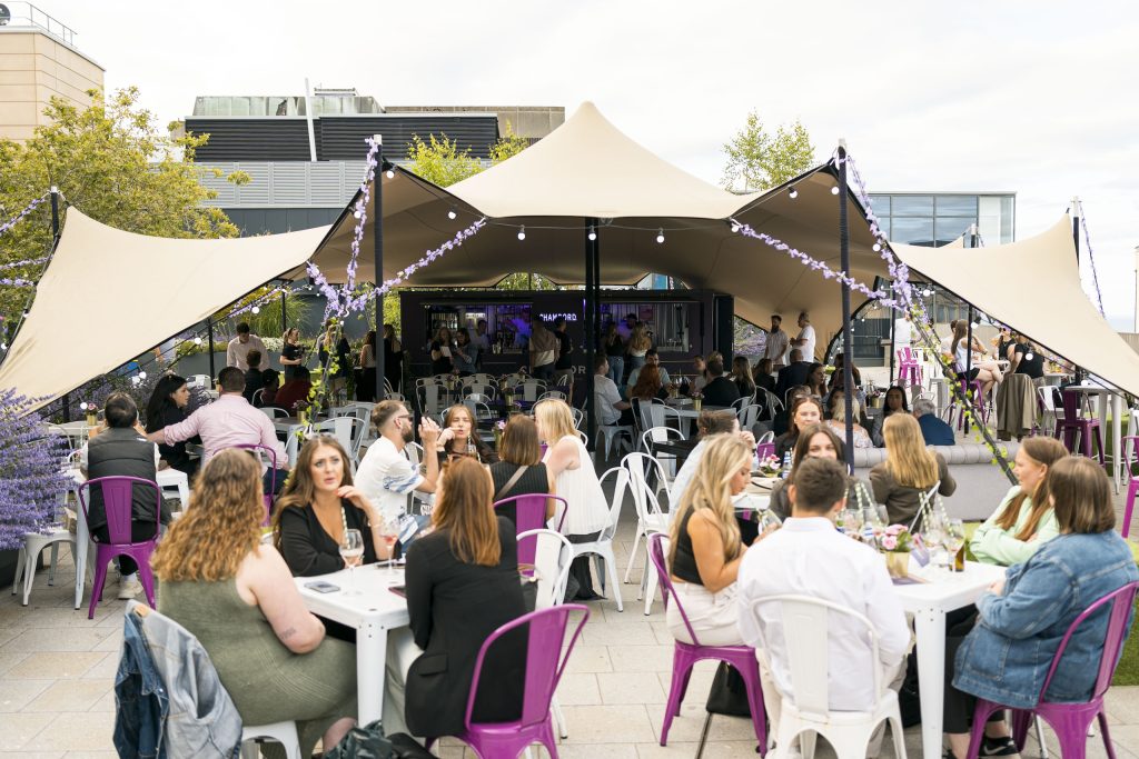 Crowd Enjoy The Sun At Skyline Sips Rooftop Bar At St James Quarter